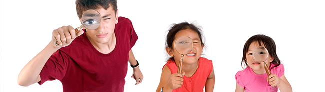 children looking through magnifying glasses